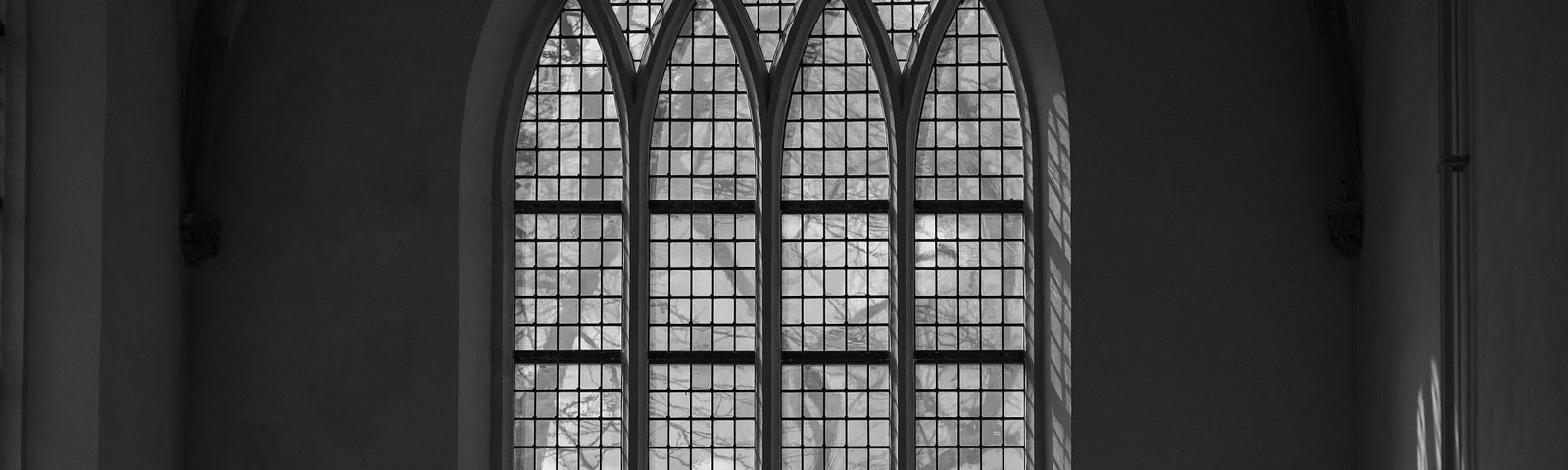 Black and white picture of an ornate cathedral window.