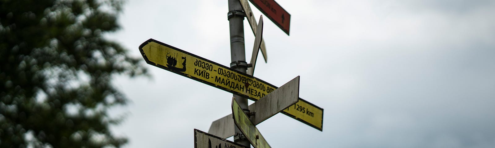 A road sign showing directions to many different places