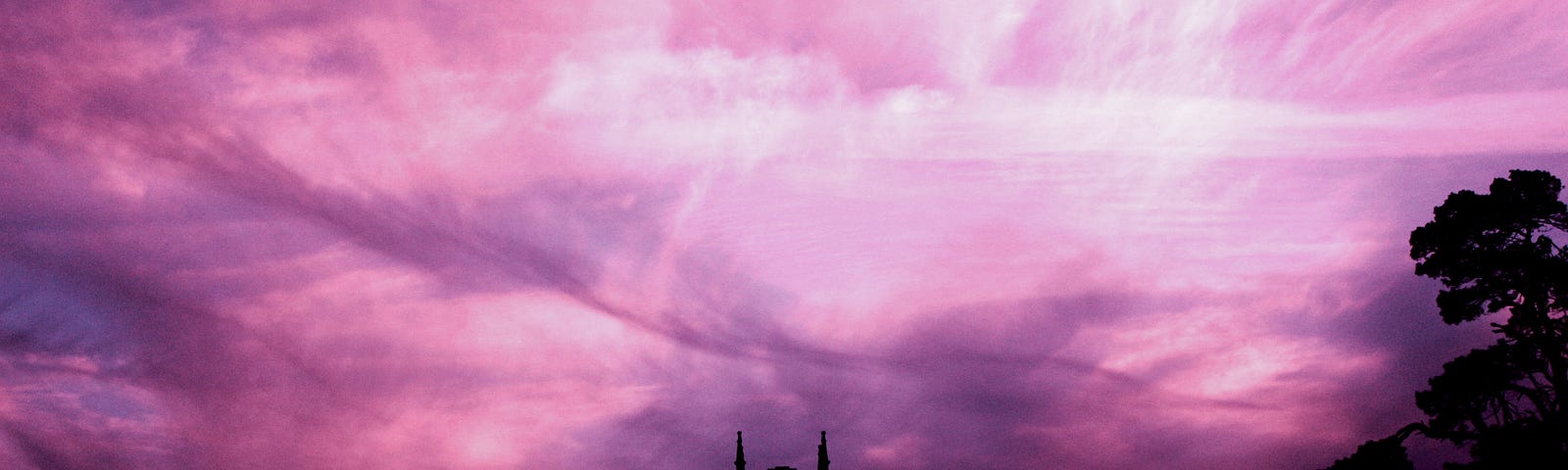 A chapel against a purple and pink sunset