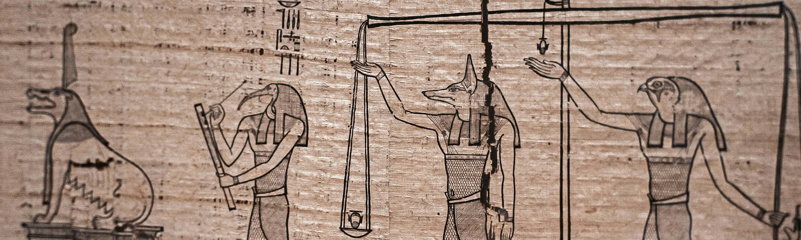 Frayed papyrus in the Egyptian Museum in Cairo. It depicts the ancient Egyptian deities Ammit (‘Devourer of the Dead’), Thoth, Anubis and Horus (from left to right) next to the scales of judgement by which the dead were judged.