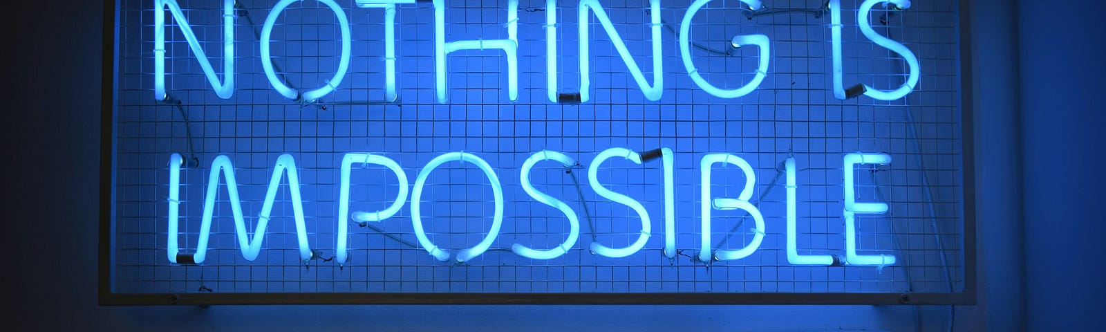 A blue neon sign reading “Nothing is Impossible”