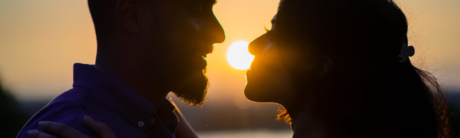 Silhouette of a man and women staring loving at each other