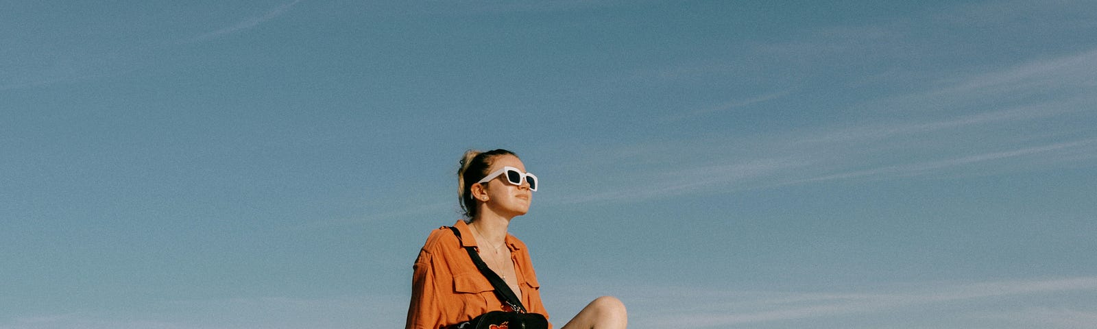 Woman on rocks sitting in the sun.