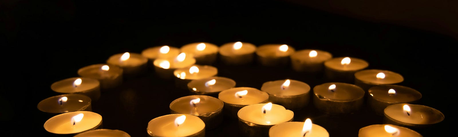 Several candles arranged to form the symbol of peace.