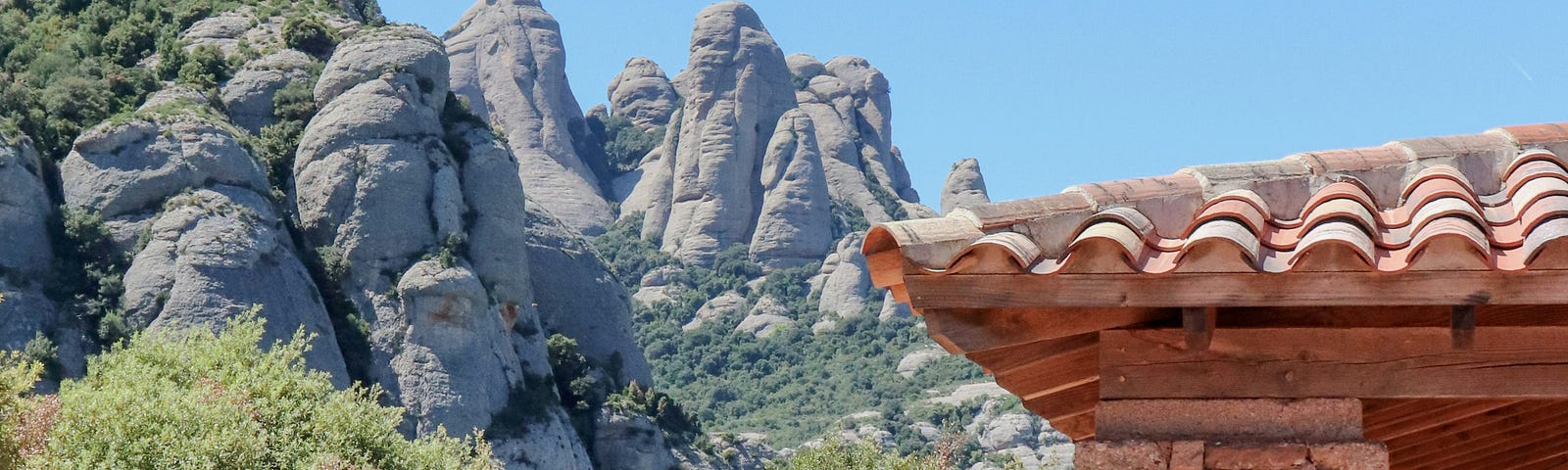 A stone structure with mountains in the background.