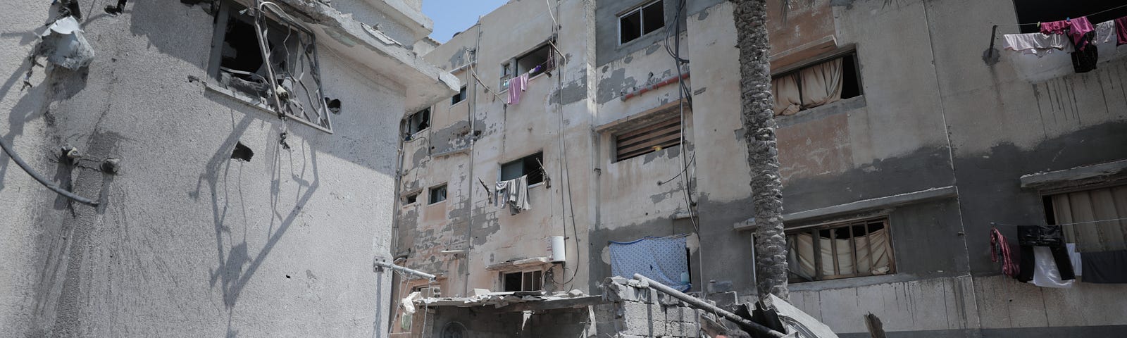 Photo of destroyed Gaza neighborhood with teens.