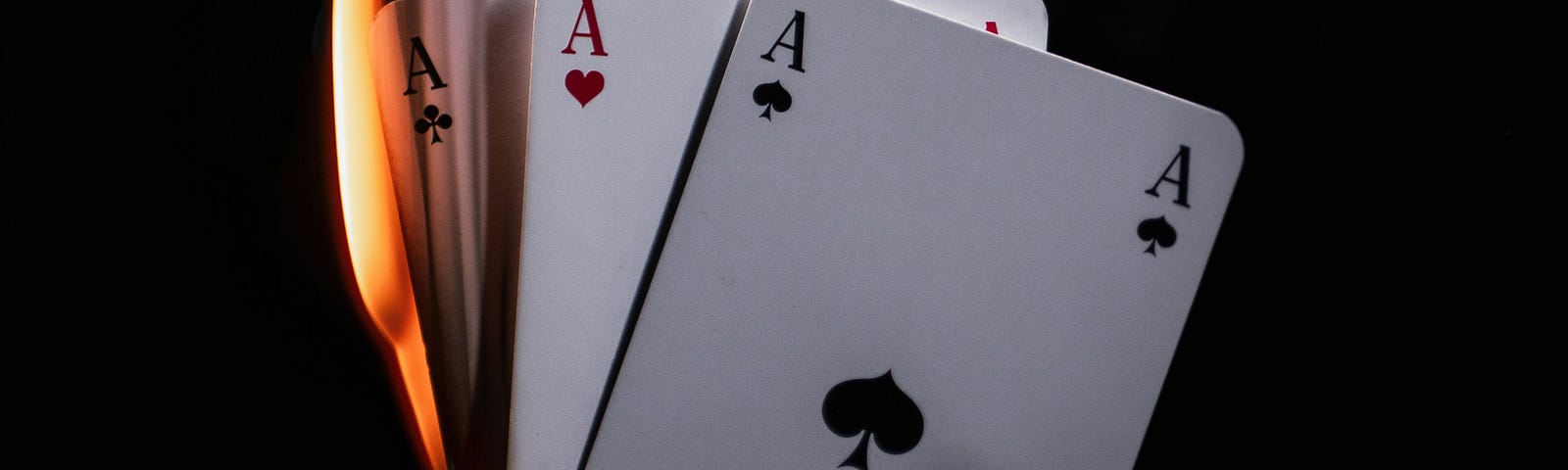 Hand holding cards-Aces that are on fire