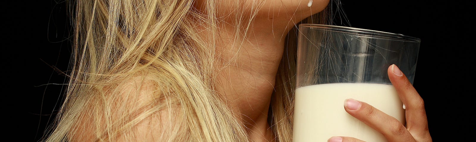 a woman in ecstasy, clutching a glass of milk to her chest.