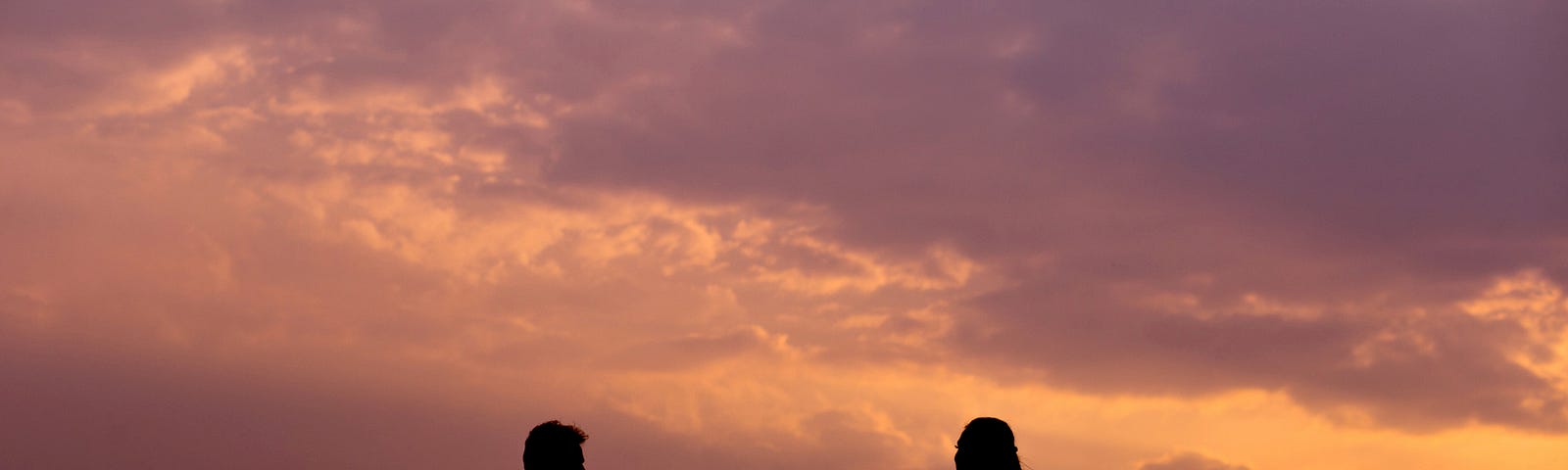 a couple on bikes at the sunset