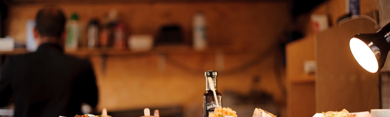 A burrito bar, with several dishes on plates sat out