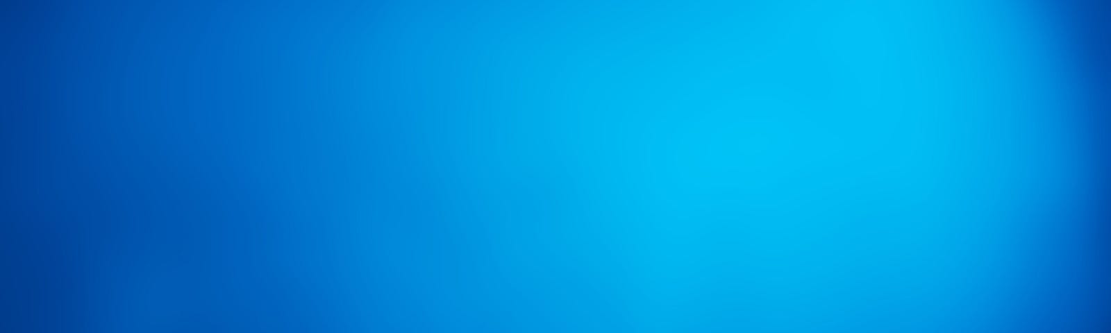 A half-closed laptop on a blue background
