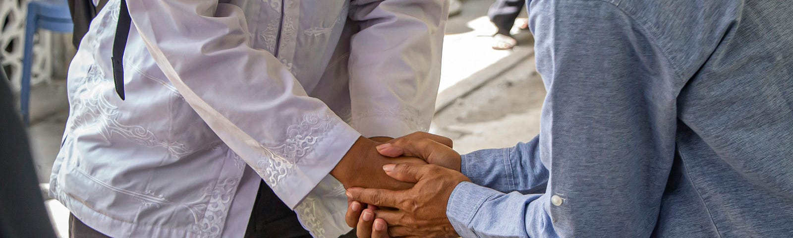 close-up of two people greeting each other with their hands
