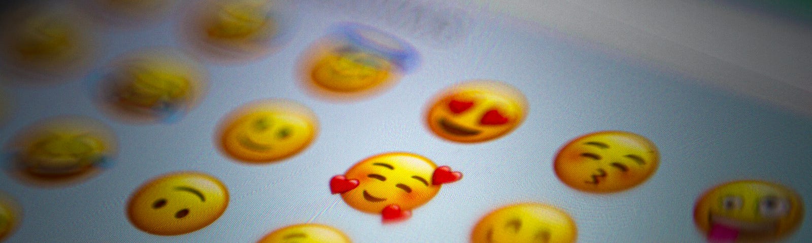 A screenshot of emoji’s centered on a smiley face with hearts.