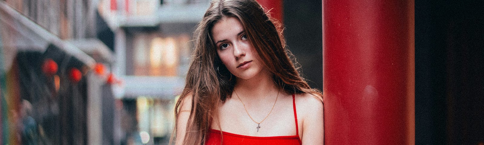 young woman with sad look , in red top