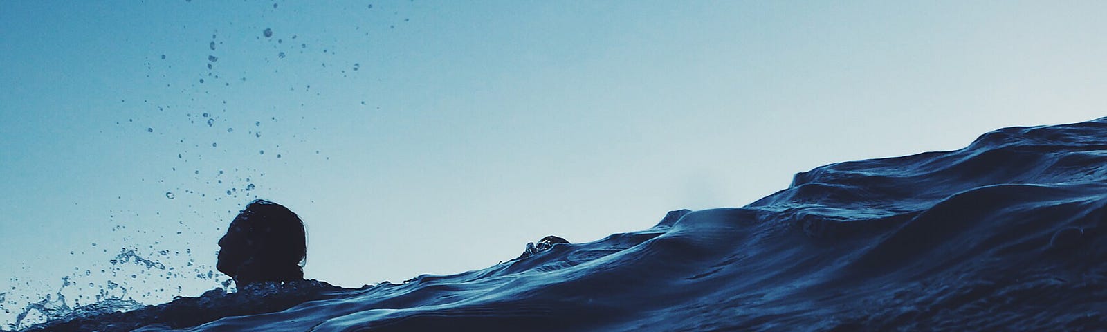 A person’s head floats just above the water