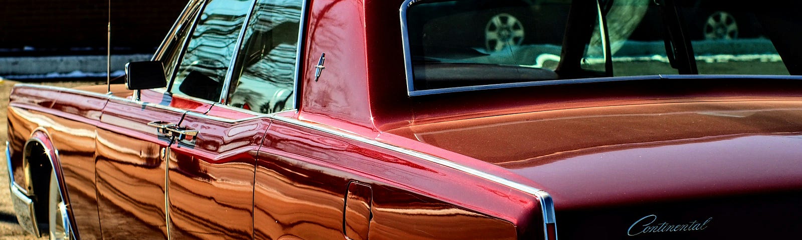 Rear end of a red Lincoln Contenental