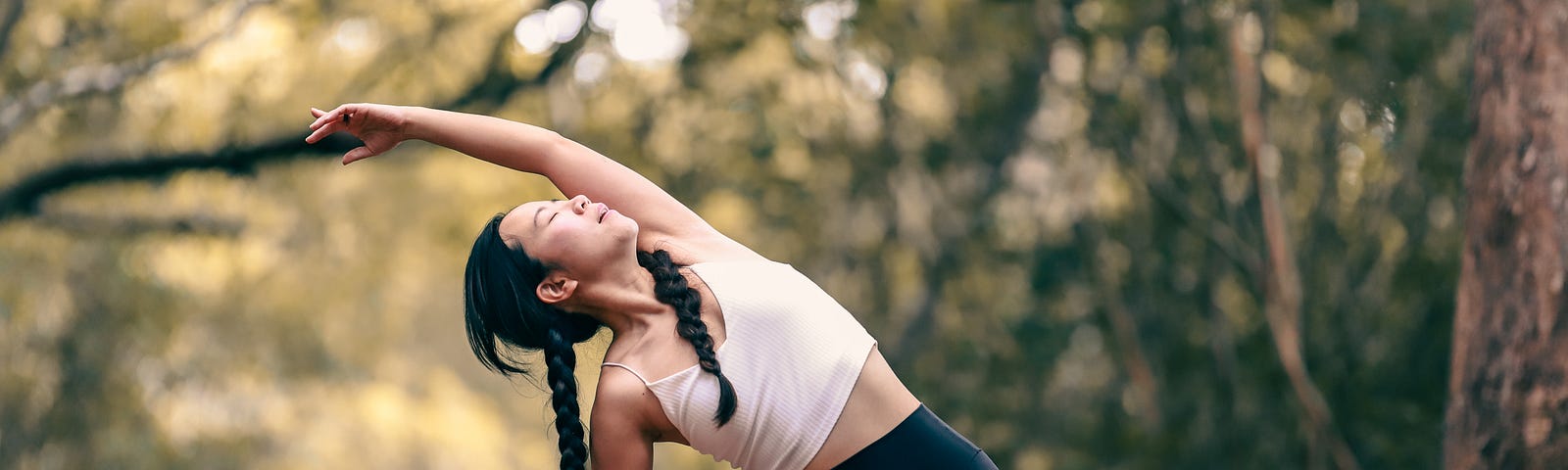 Woman doing yoga pose outside in nature