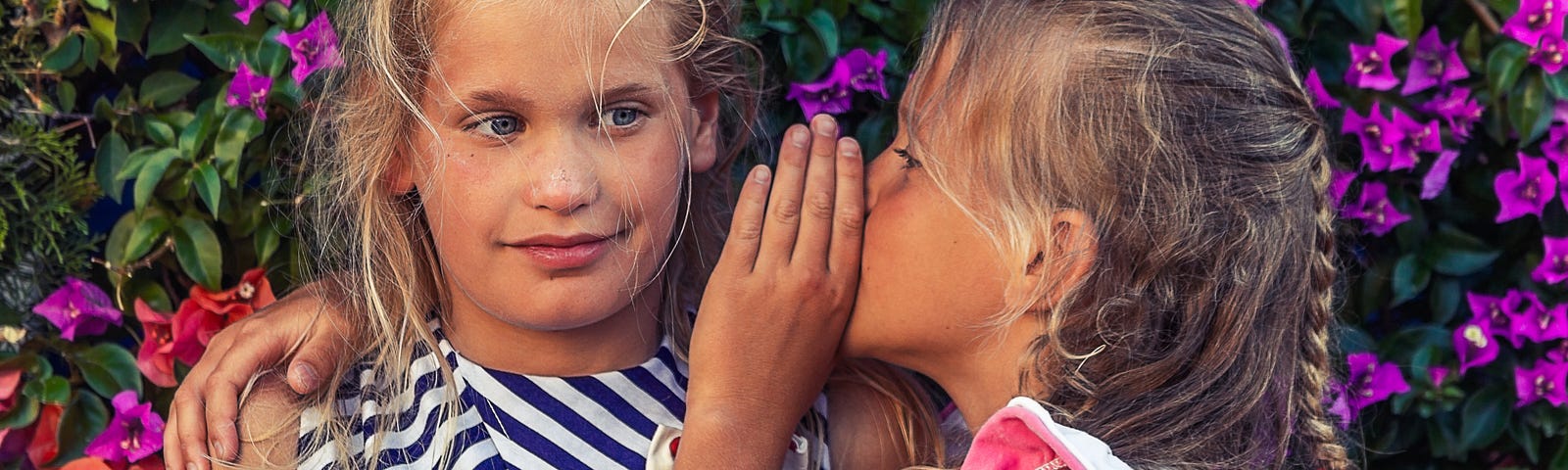 One little girl telling another little girl a secret.