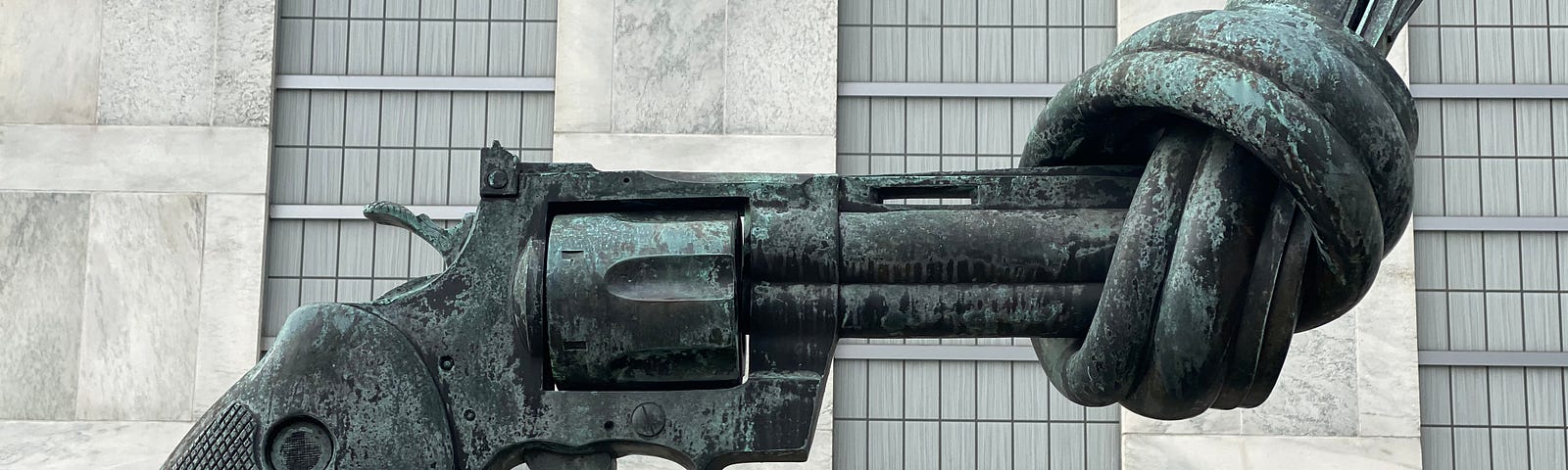 A statue of a gun, with the barrel twisted into a knot to prevent it from being able to fire.