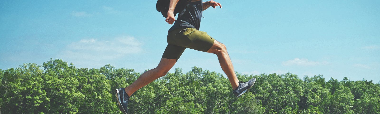 A man leaping across two concrete blocks.