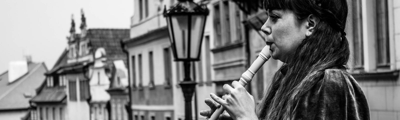 Woman playing a recorder.