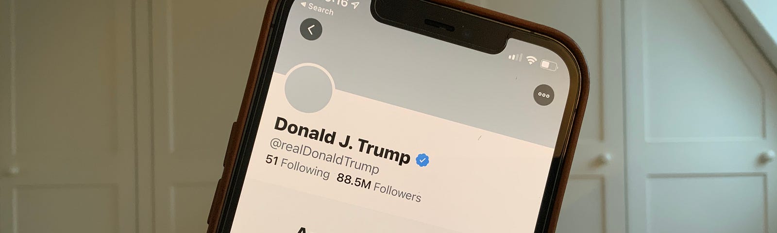 a screenshot of a cell phone showing Donald Trumps Twitter account suspended