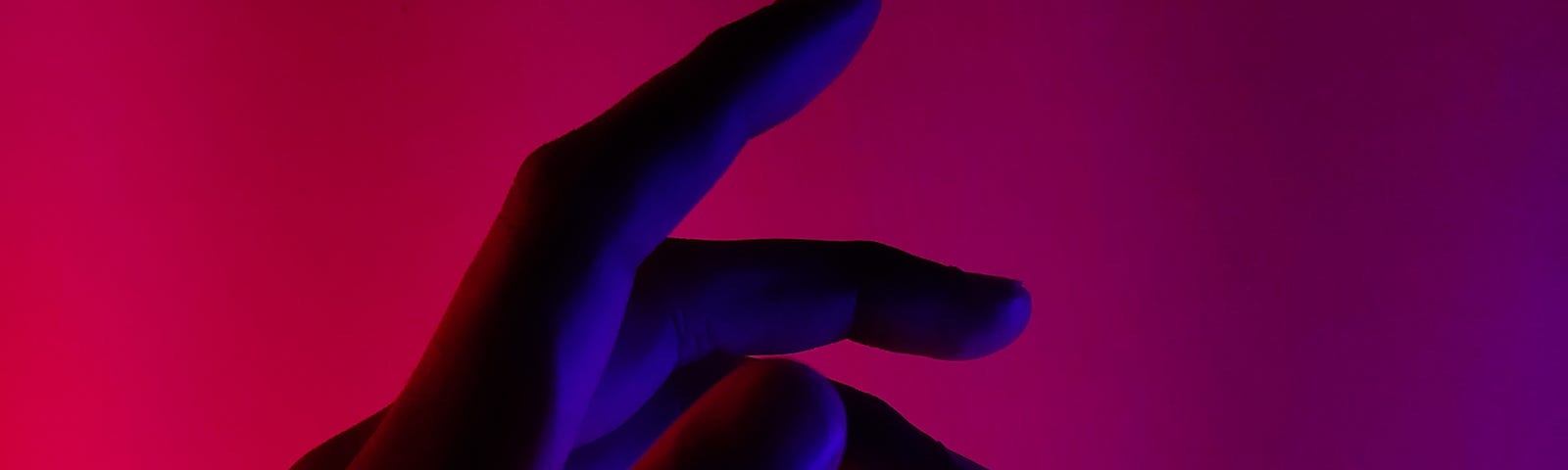 A woman’s palm against a pink background.