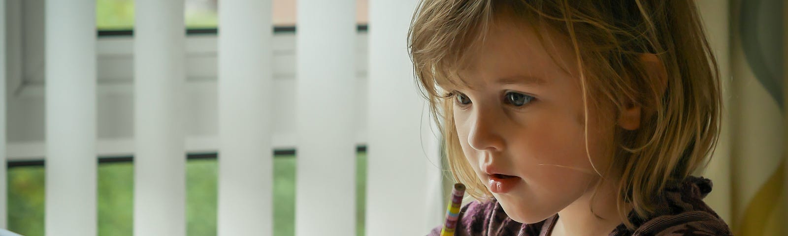 a young girl is doing her homework in front of an iPad