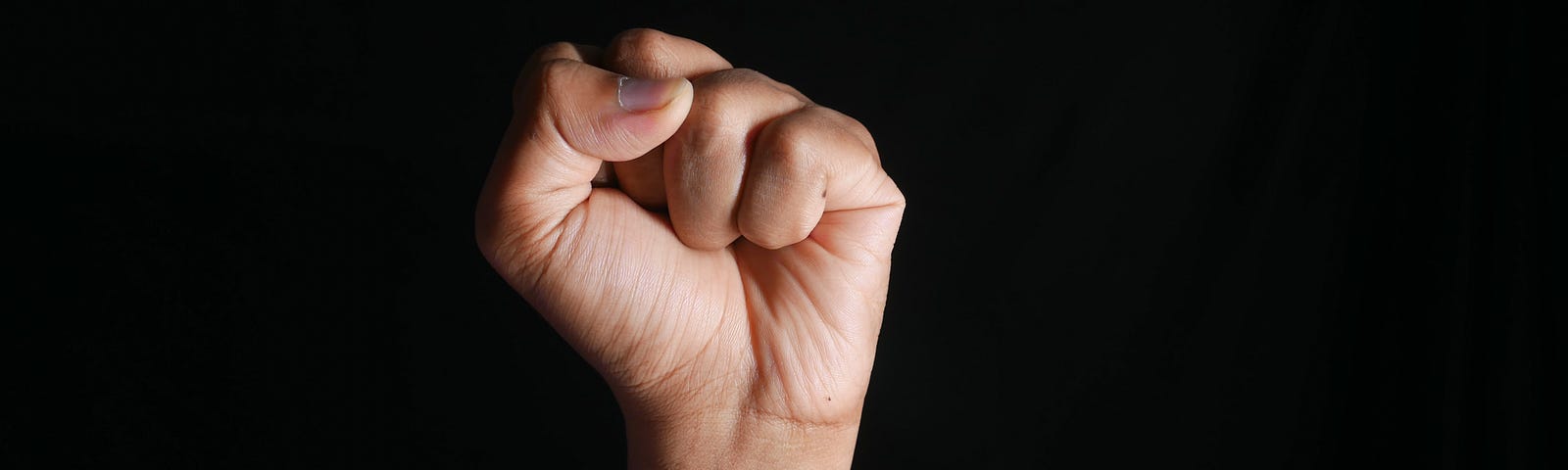 person clenching a fist