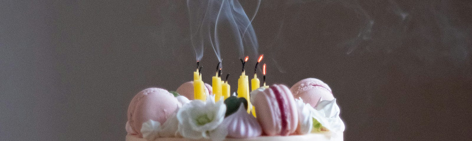 Smoke rising from recently extinguished candles on a birthday cake