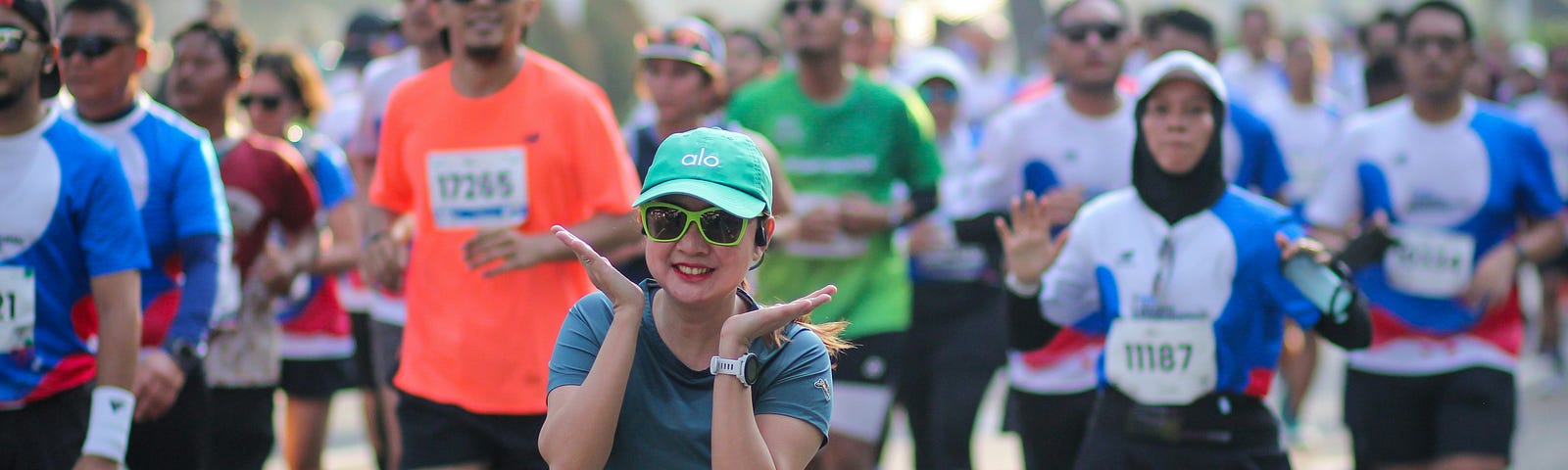 Photo of smiling woman in a race framing her face with her hands
