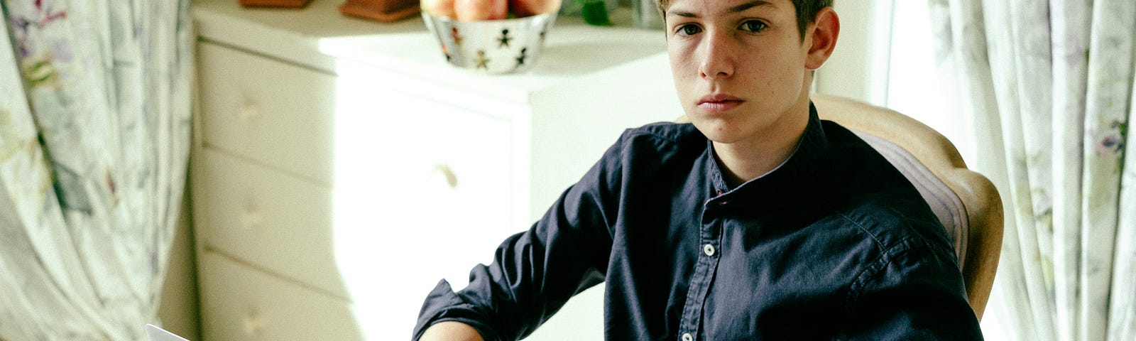 The writer pictures a young man sitting at a table in front of a computer portraying Gen Z.