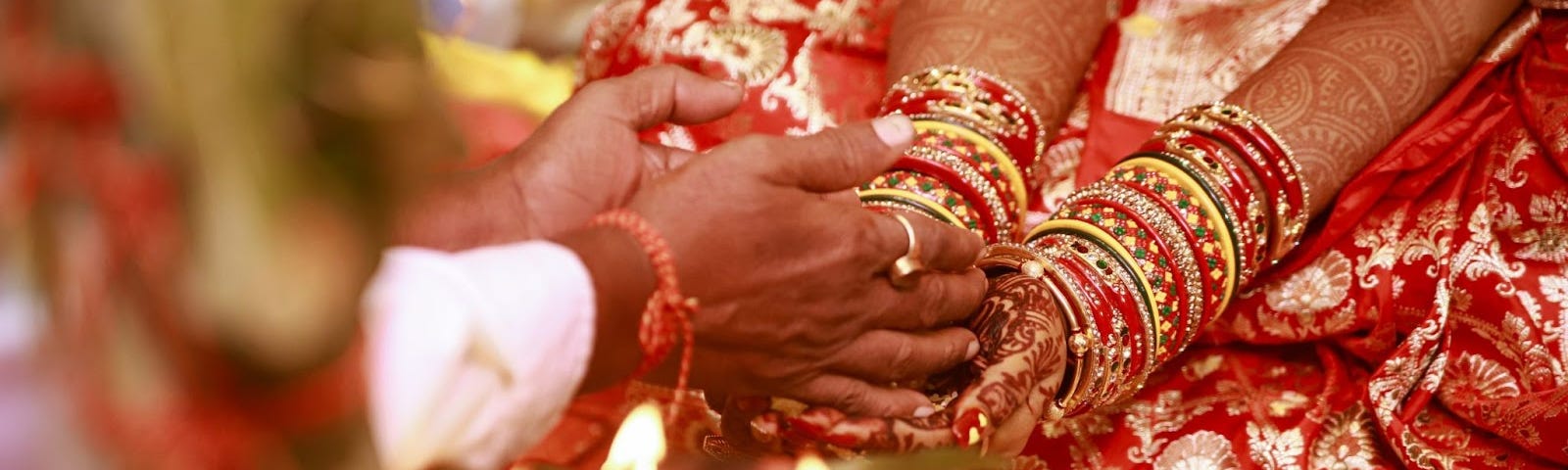 Pundit handing the bride something as she cups her hands together on her lap.