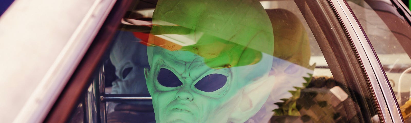 An alien costume driving a car