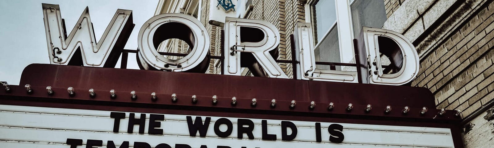 image of movie theater marquee that states the world is temporarily closed