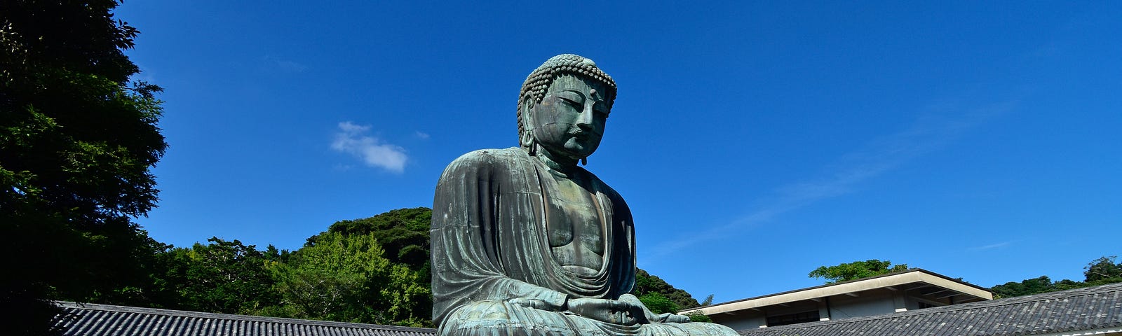 statue of The Buddha in a town square- city and country unidentified