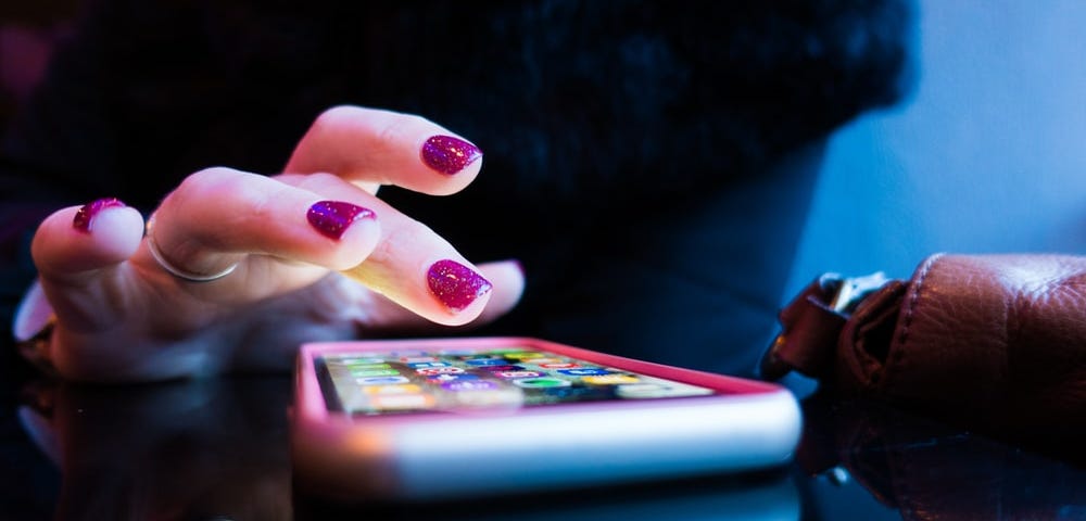 Picture of a woman’s hand using a smartphone