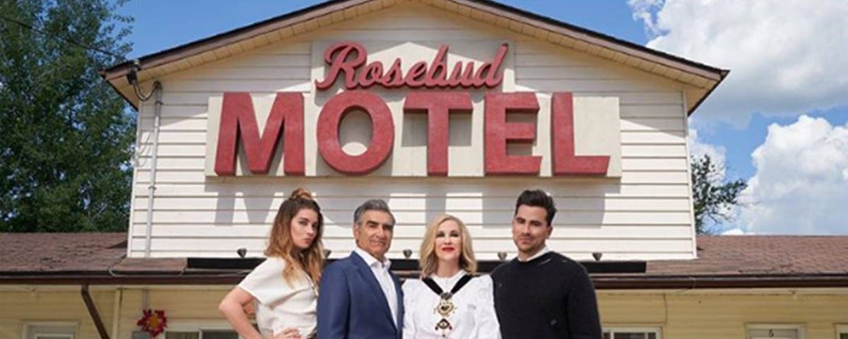 The Rose family (Alexis, Johnny, Moira, David) pose in front of their new home in Schitt’s Creek, the Rosebud Motel.