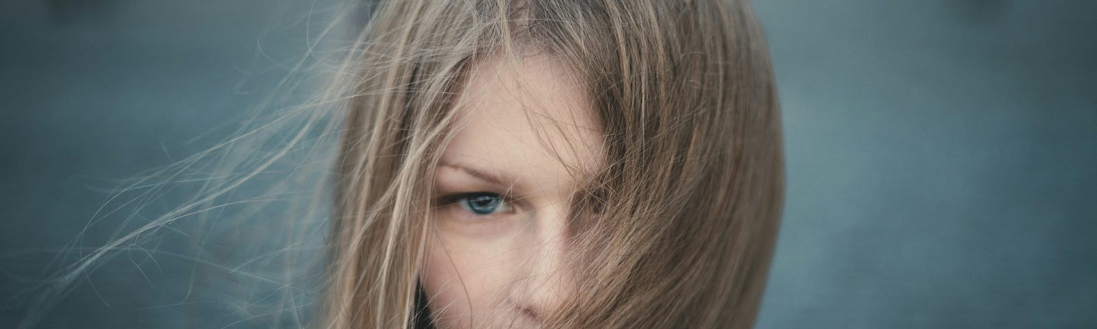 girl looking straight ahead with hair blowing in the wind