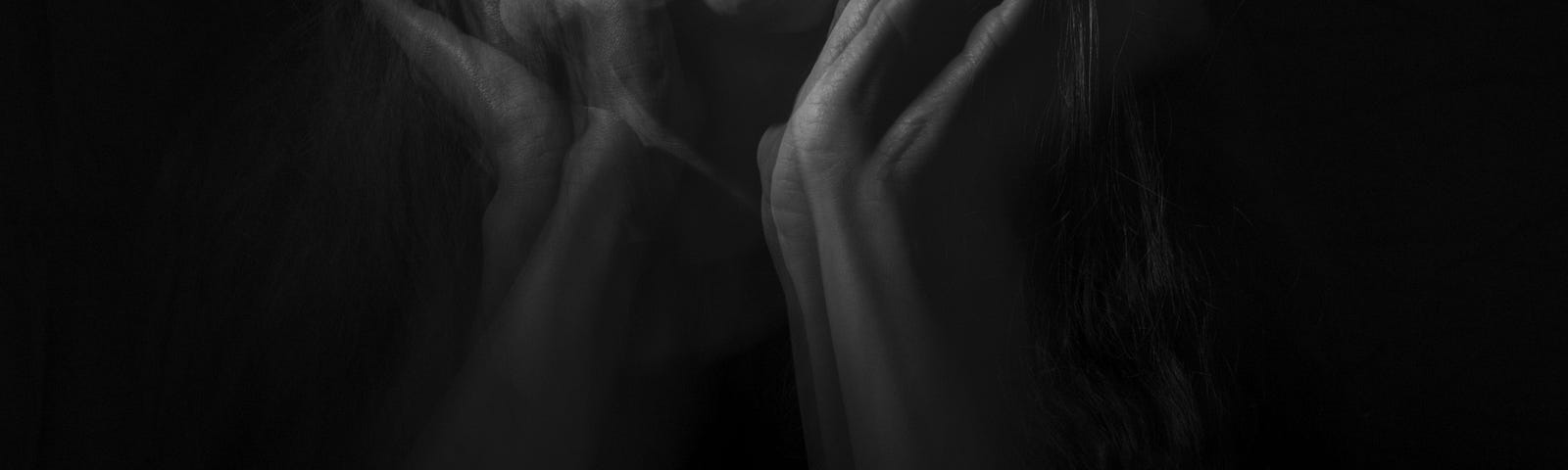 black and white image of woman screaming in abstract ghostly imagery