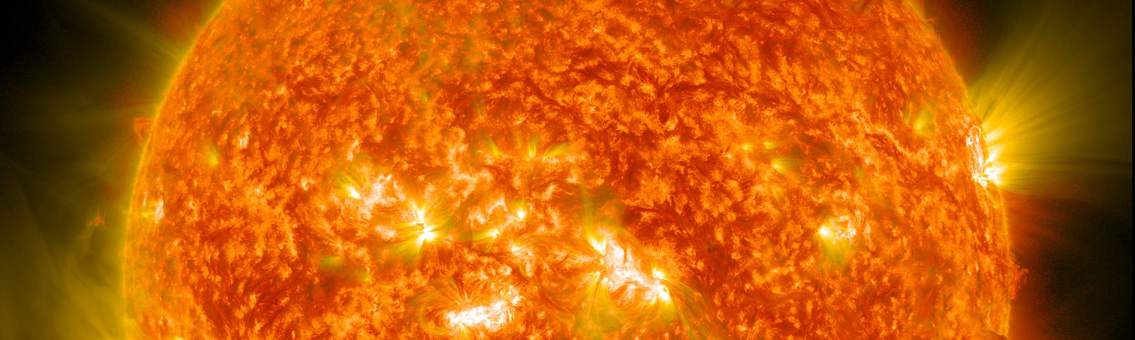 A blazing bright orange sun in close-up.