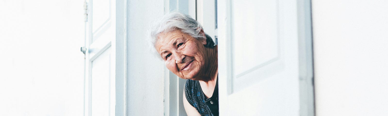 An old lady peeking through a window