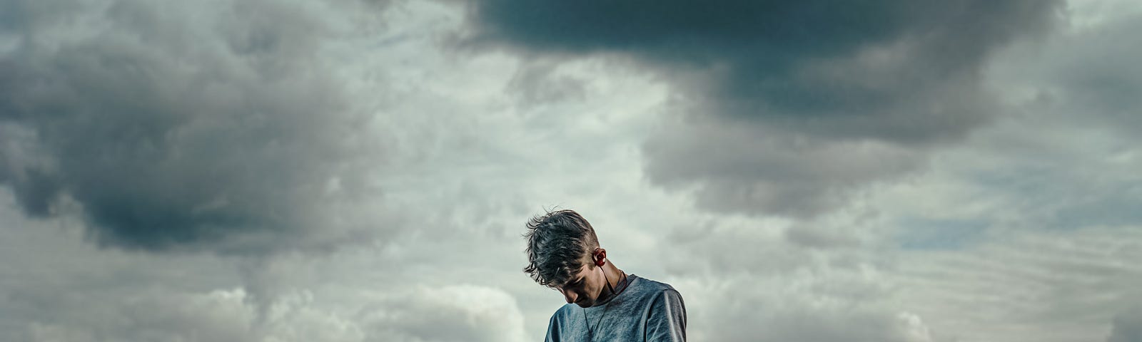 man standing on a rock at the ocean