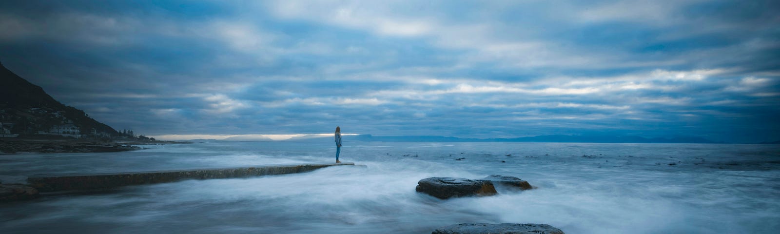 Person standing by the water’s edge