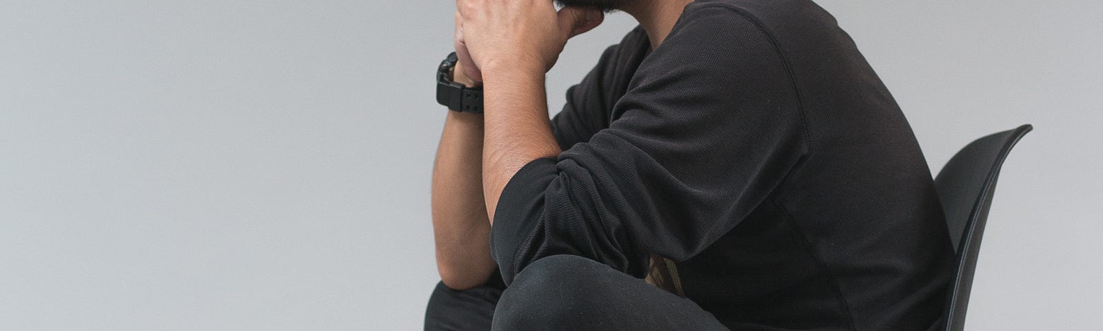 A young black man sits cross-legged on a simple chair. He faces to our left. A new study shows that high and low levels of high-density lipoprotein cholesterol (HDL-C) — but not levels of low-density lipoprotein cholesterol (LDL-C) are associated with increased dementia risk.