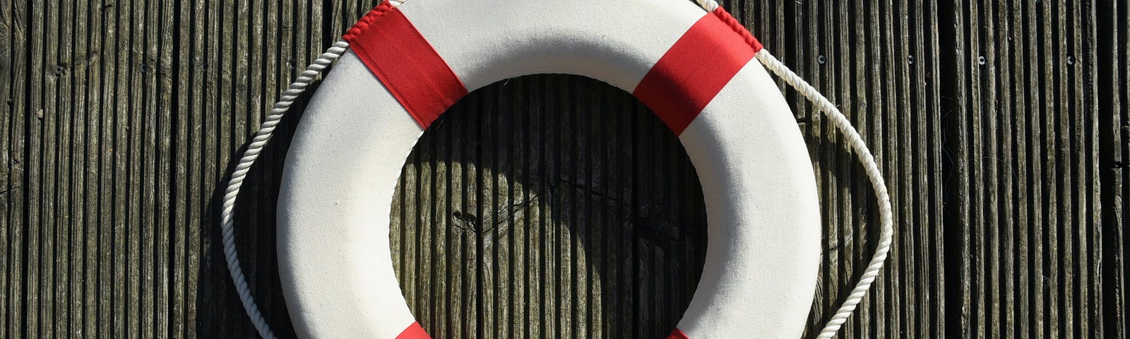 white life buoy (or life saver or life preserver) with red stripes