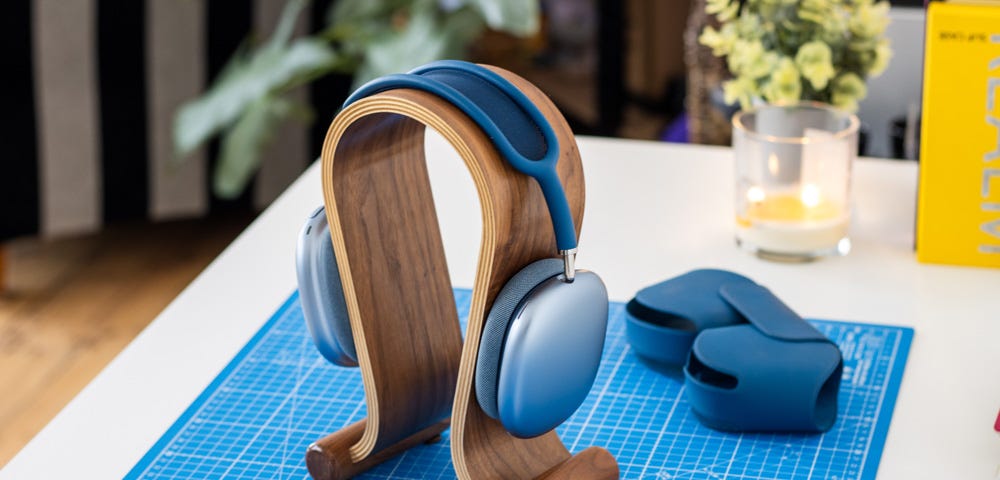 AirPods Max in blue on desk with case