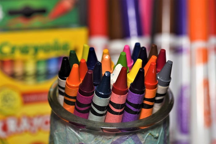 A jar filled with new crayons.