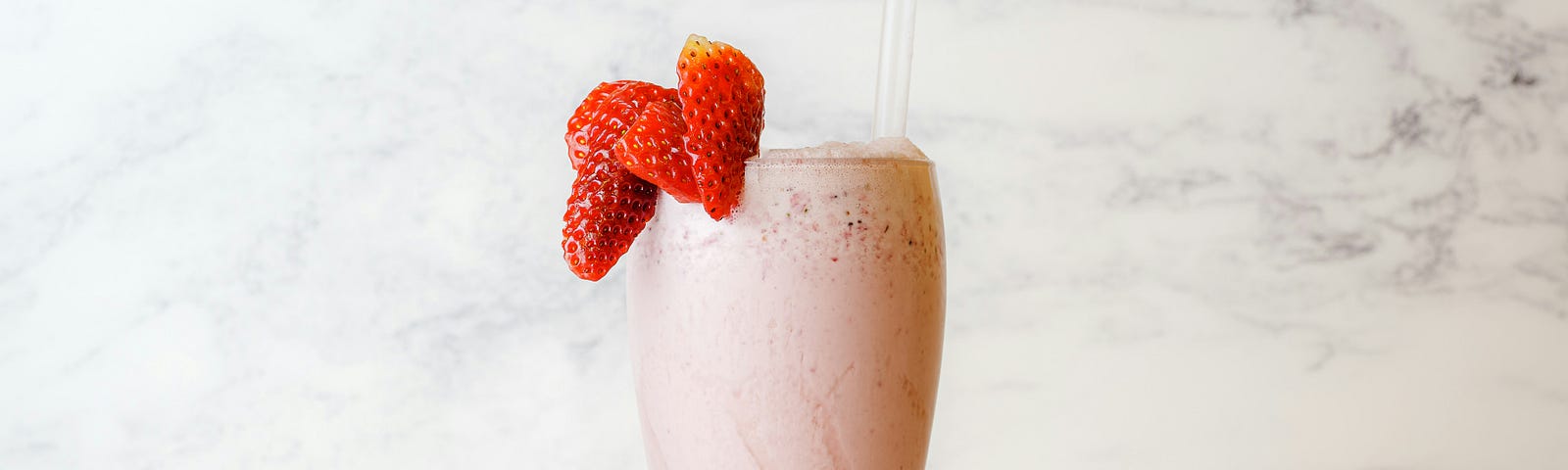 Strawberry shake with fresh strawberry garnish