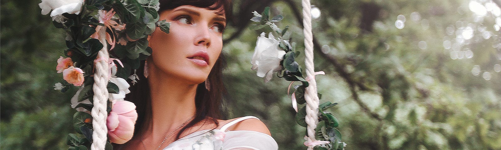 Princess sitting outside on a swing with flowers